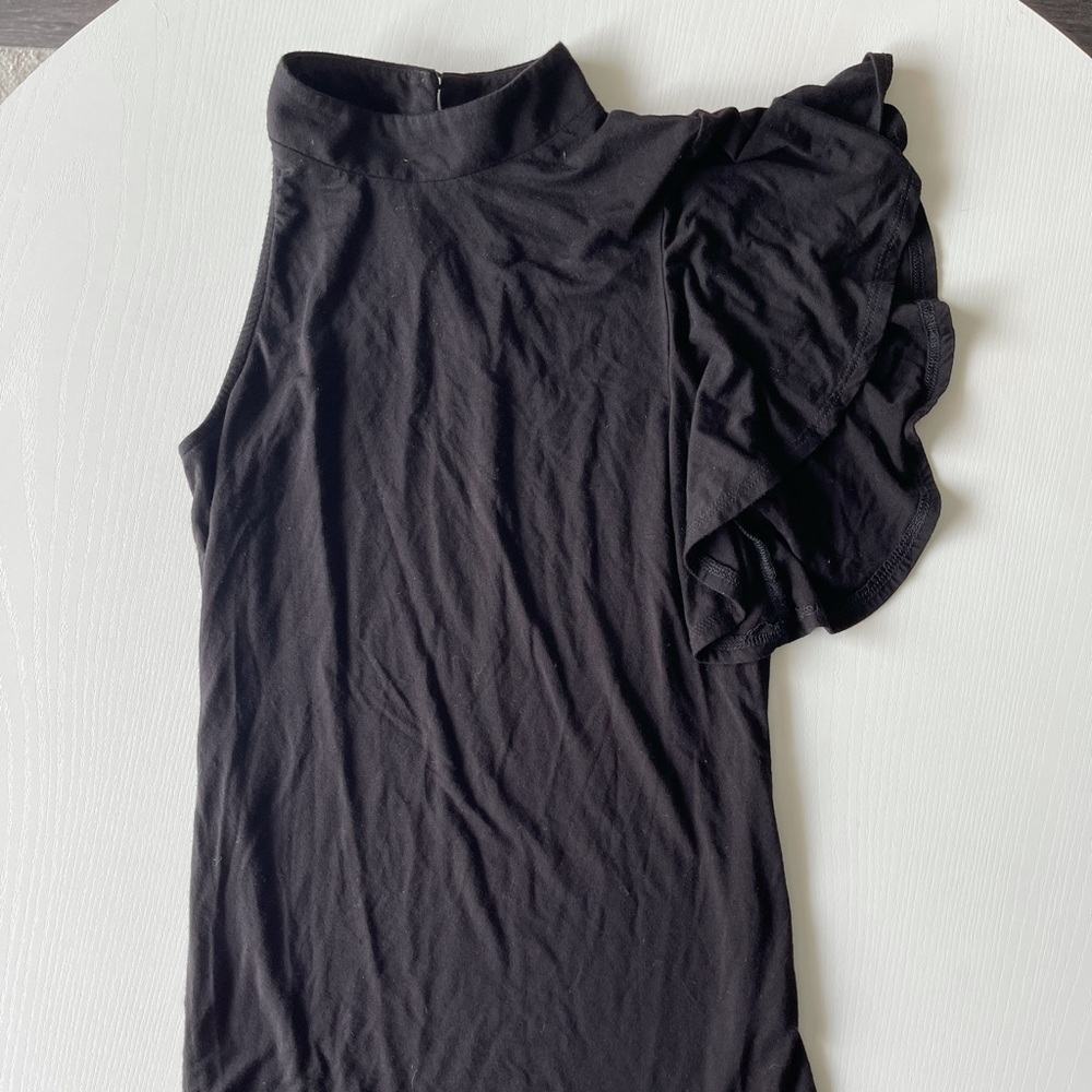 Black one sleeved top.